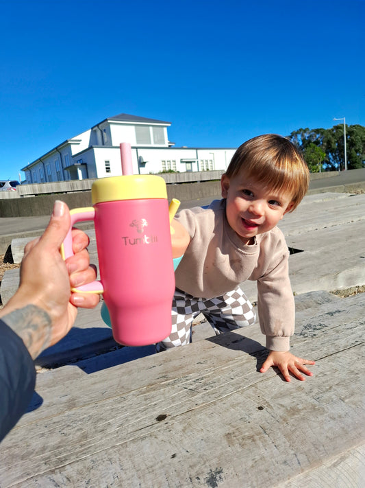 Child reaching out with stainless steel toddler tumbler