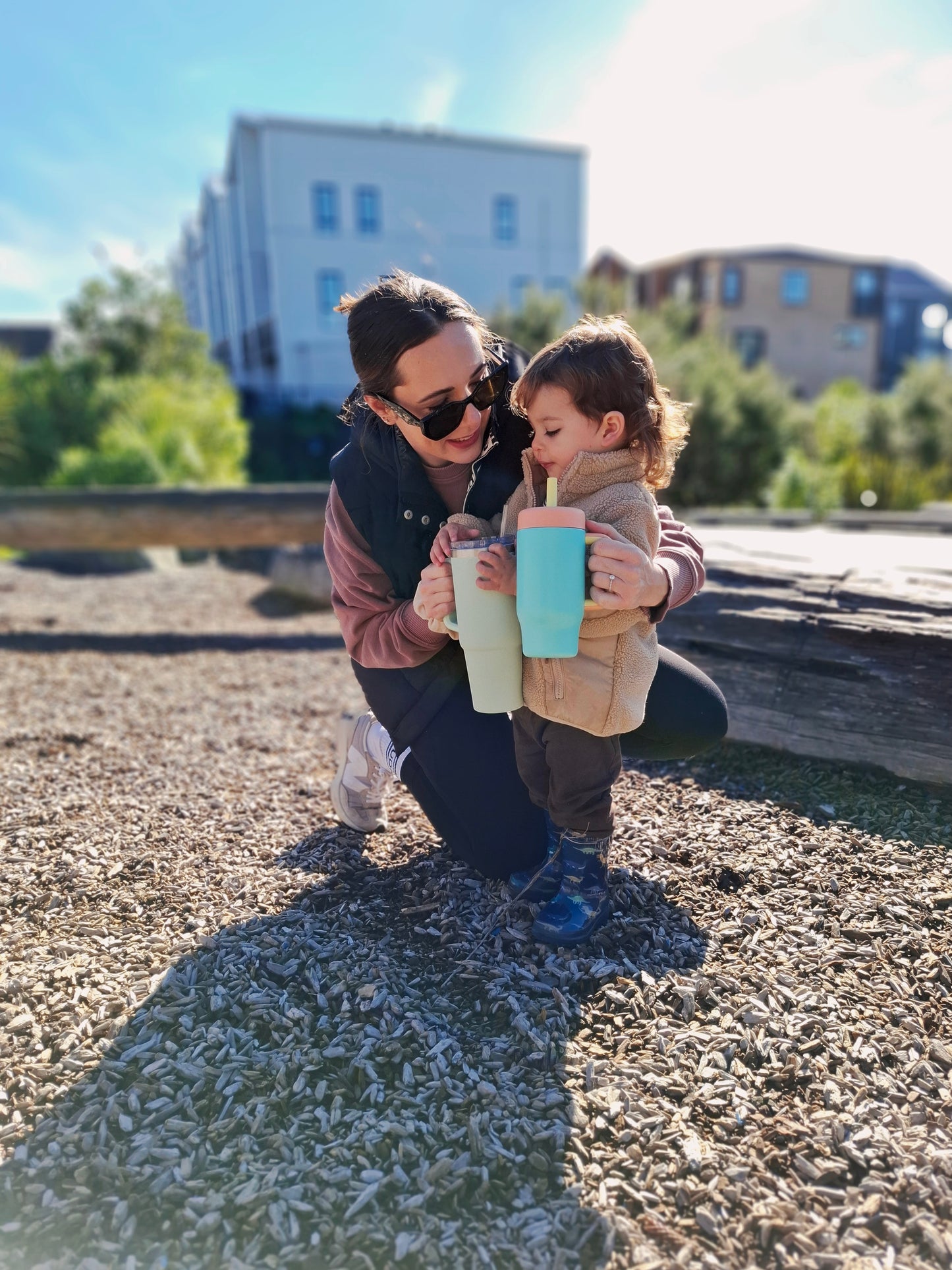 Mum and toddler holding matching stainless steel tumblers
